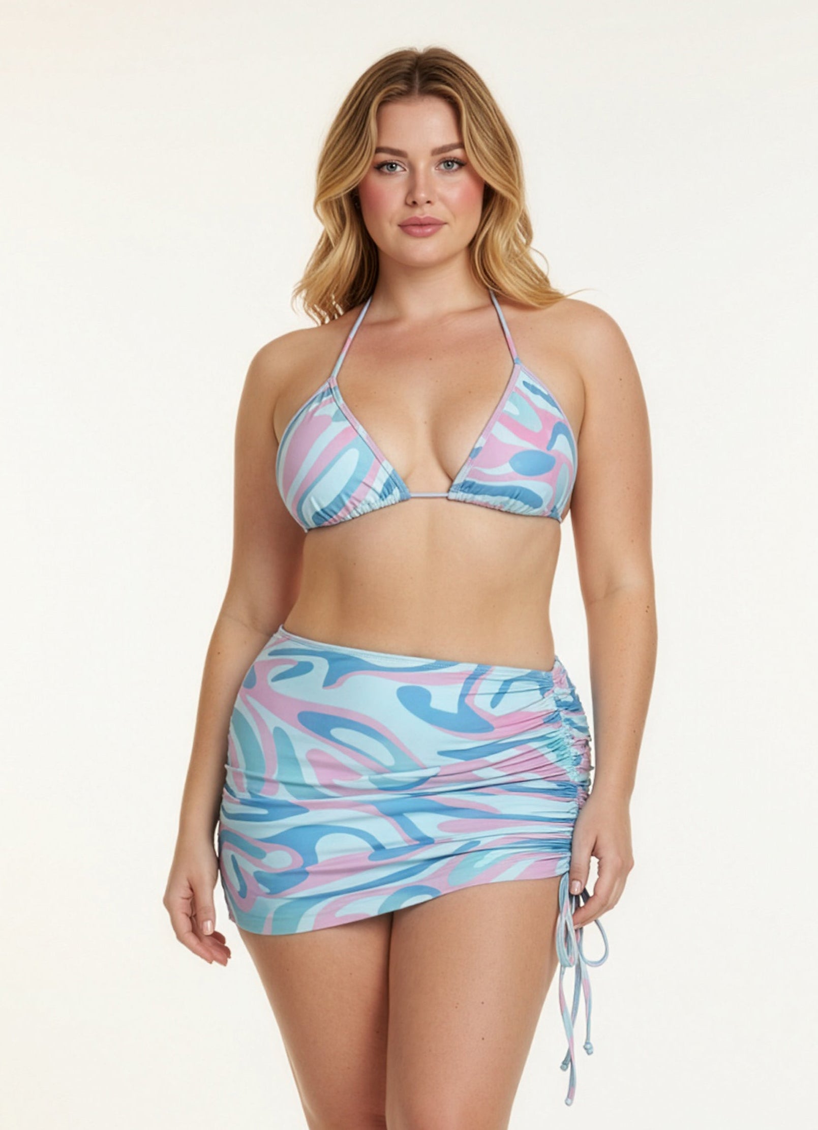 Woman wearing a colorful bikini with a patterned skirt on a white background