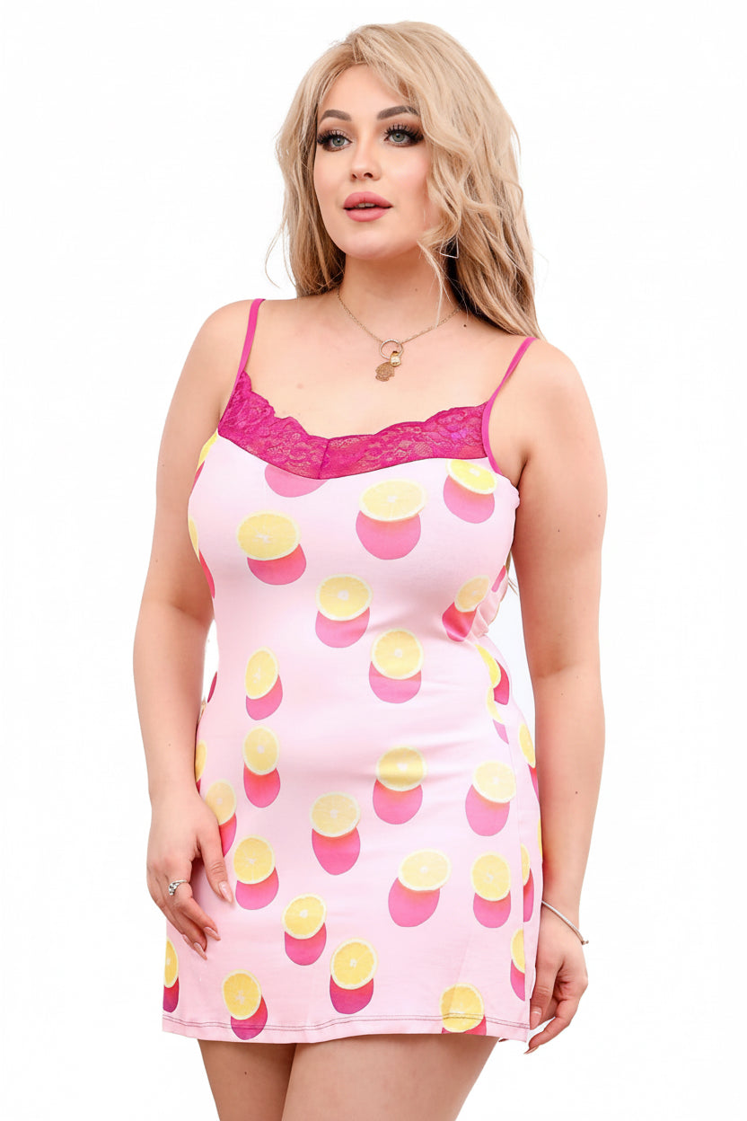 Woman wearing a pink nightgown with yellow and pink polka dot pattern on a white background