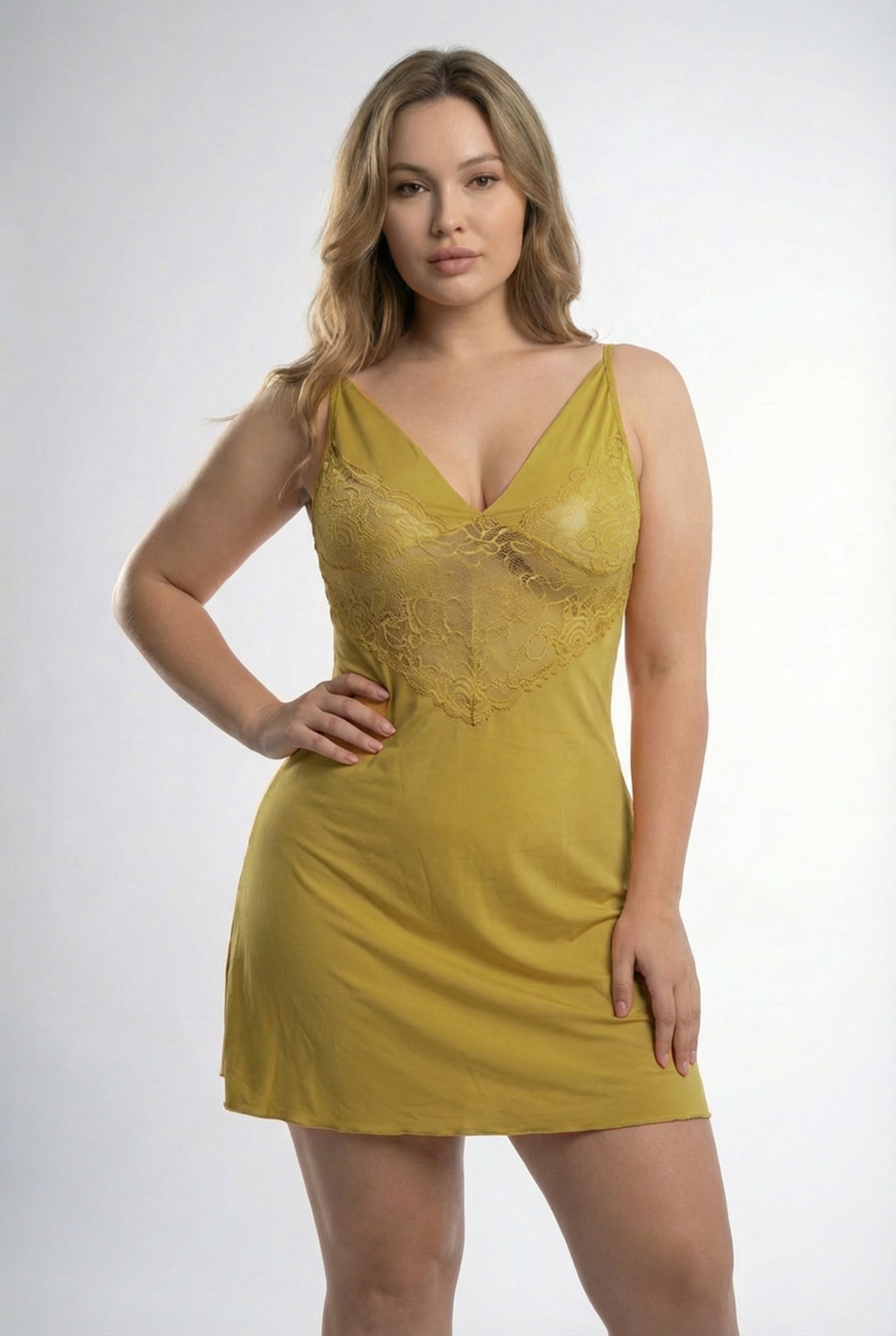 Woman wearing a yellow lace nightgown against a white background