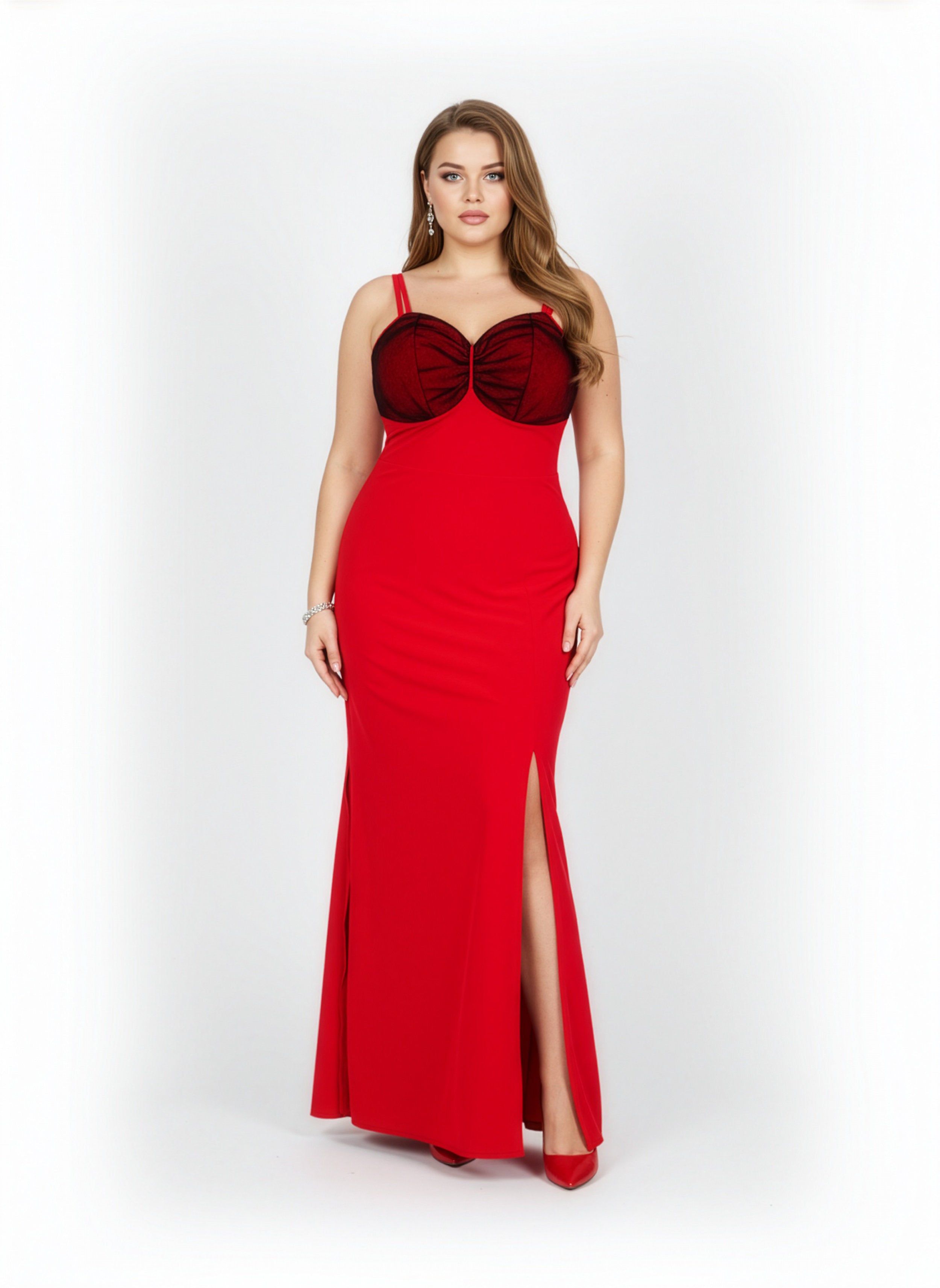 Woman wearing a red evening gown with a black bralette on a white background