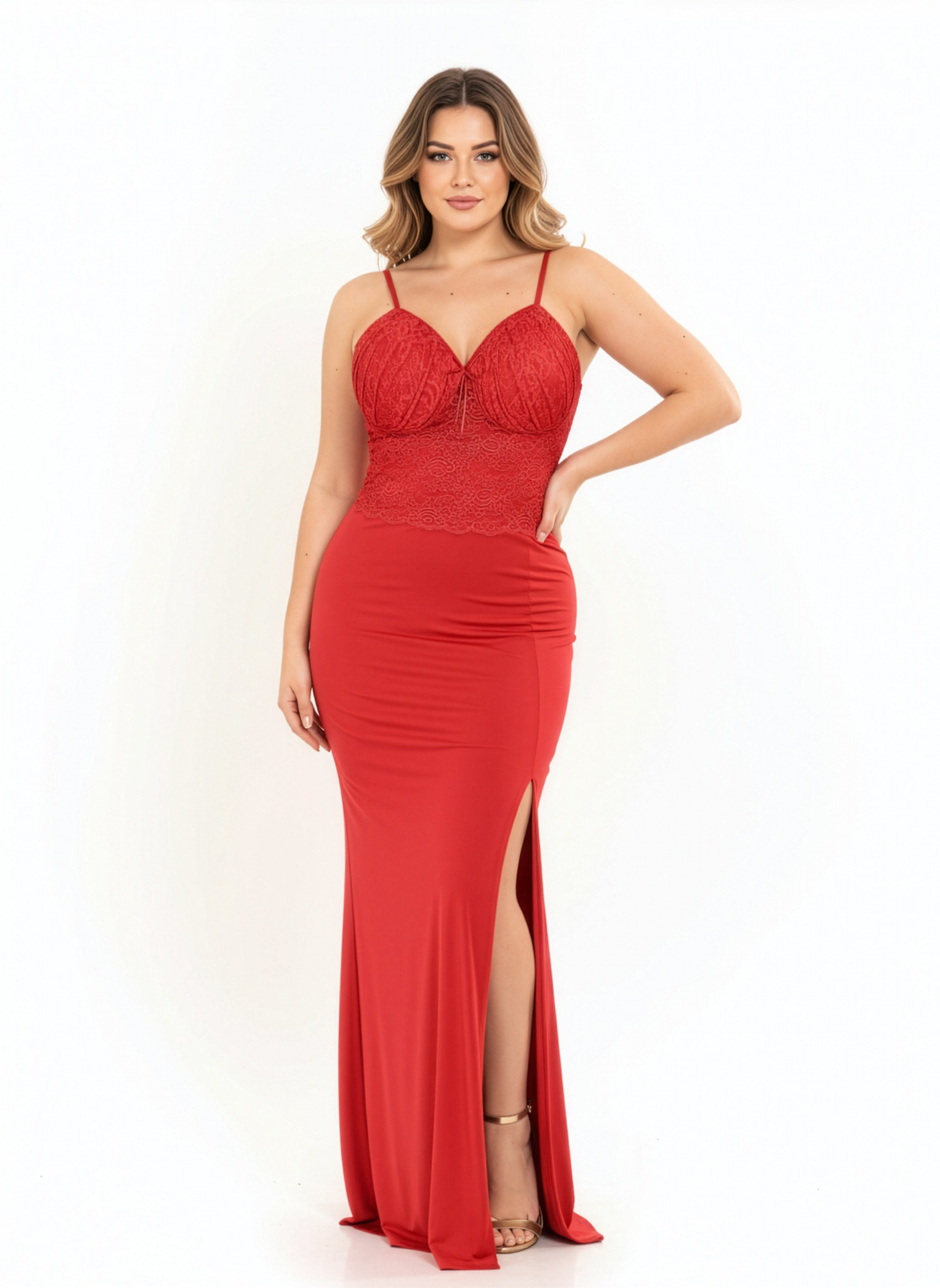 Woman wearing a red evening gown with a slit on a white background