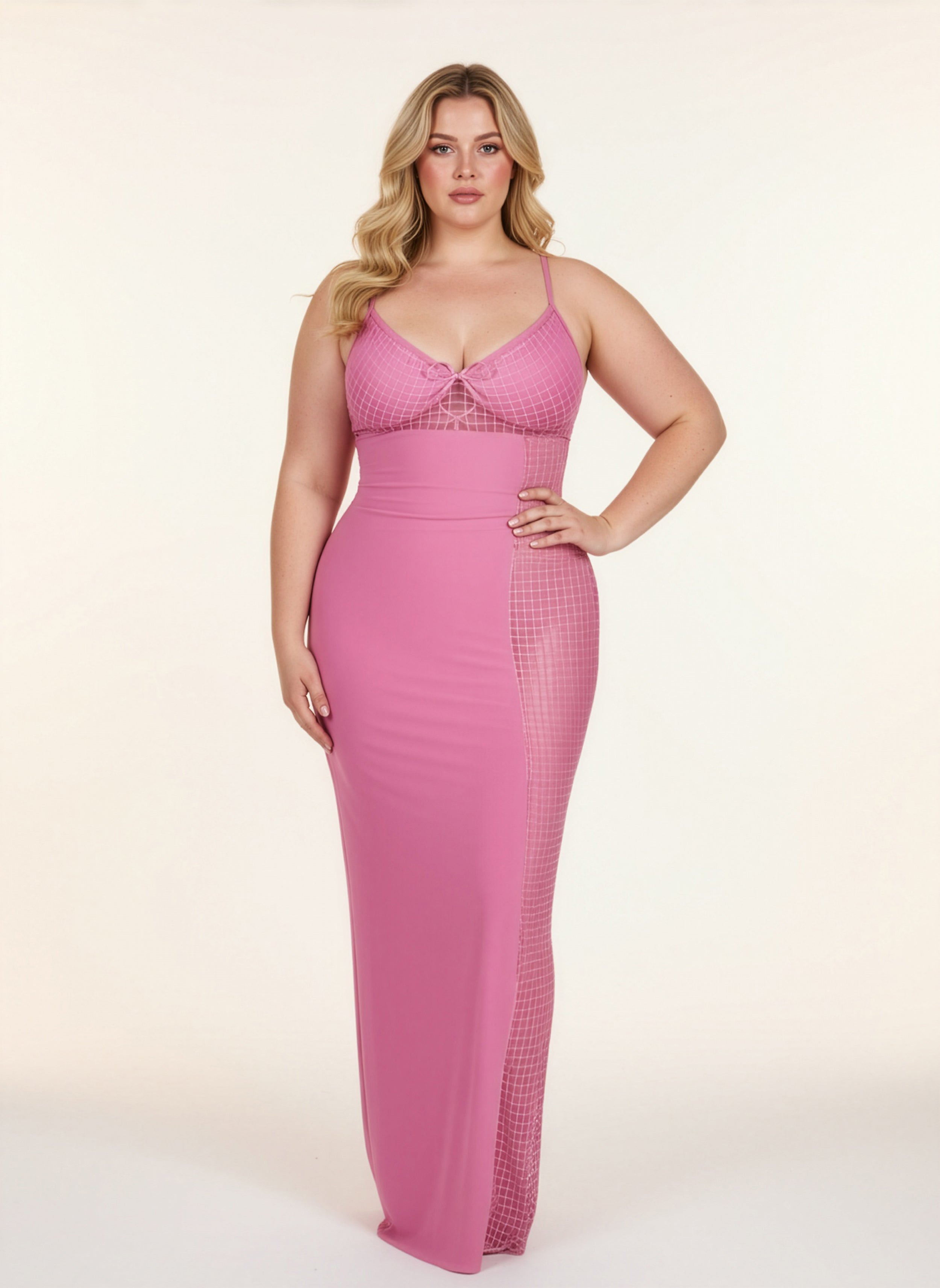 Woman wearing a pink dress with a textured pattern on a white background