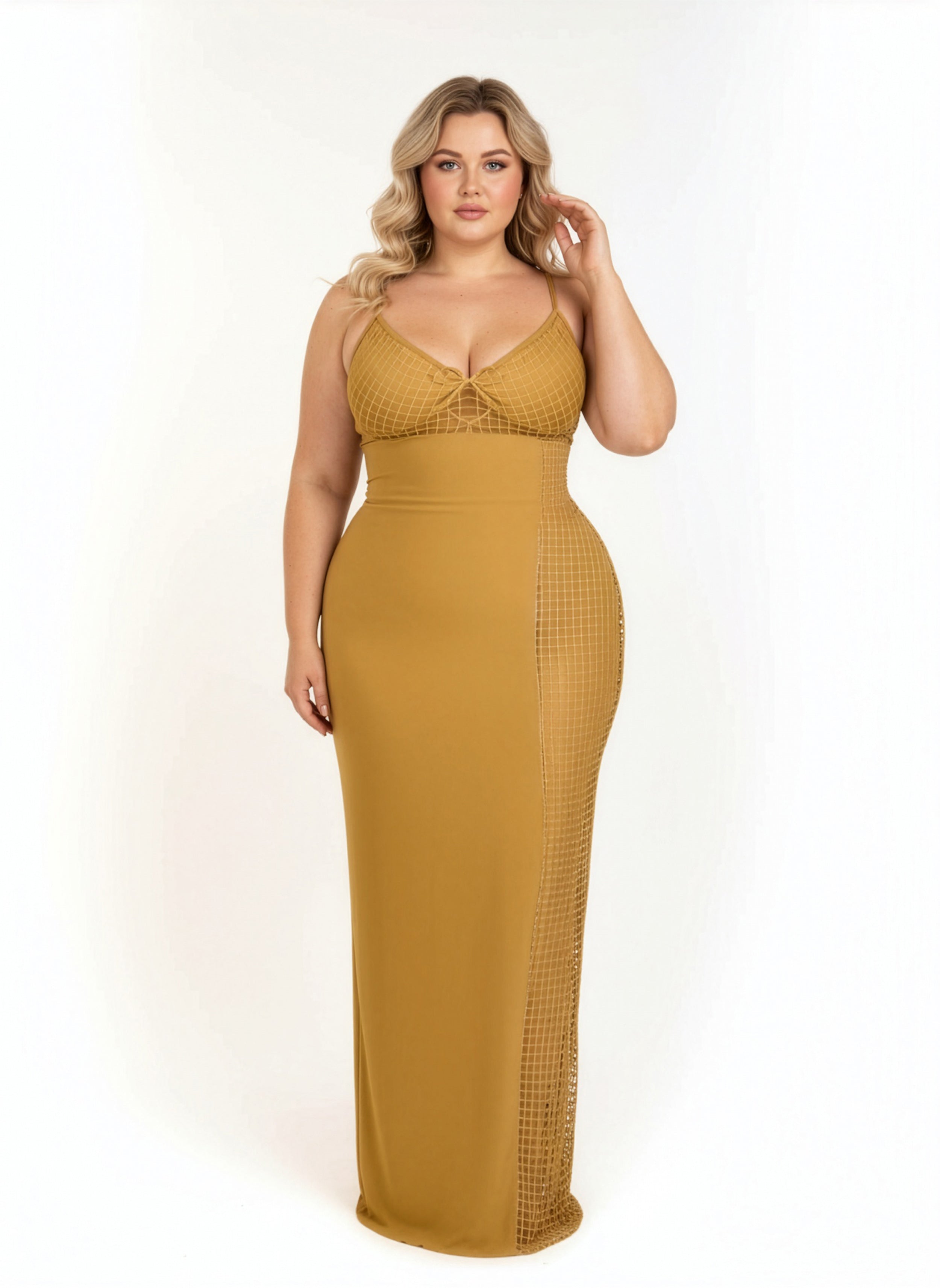 Woman wearing a mustard yellow dress with mesh panels on a white background
